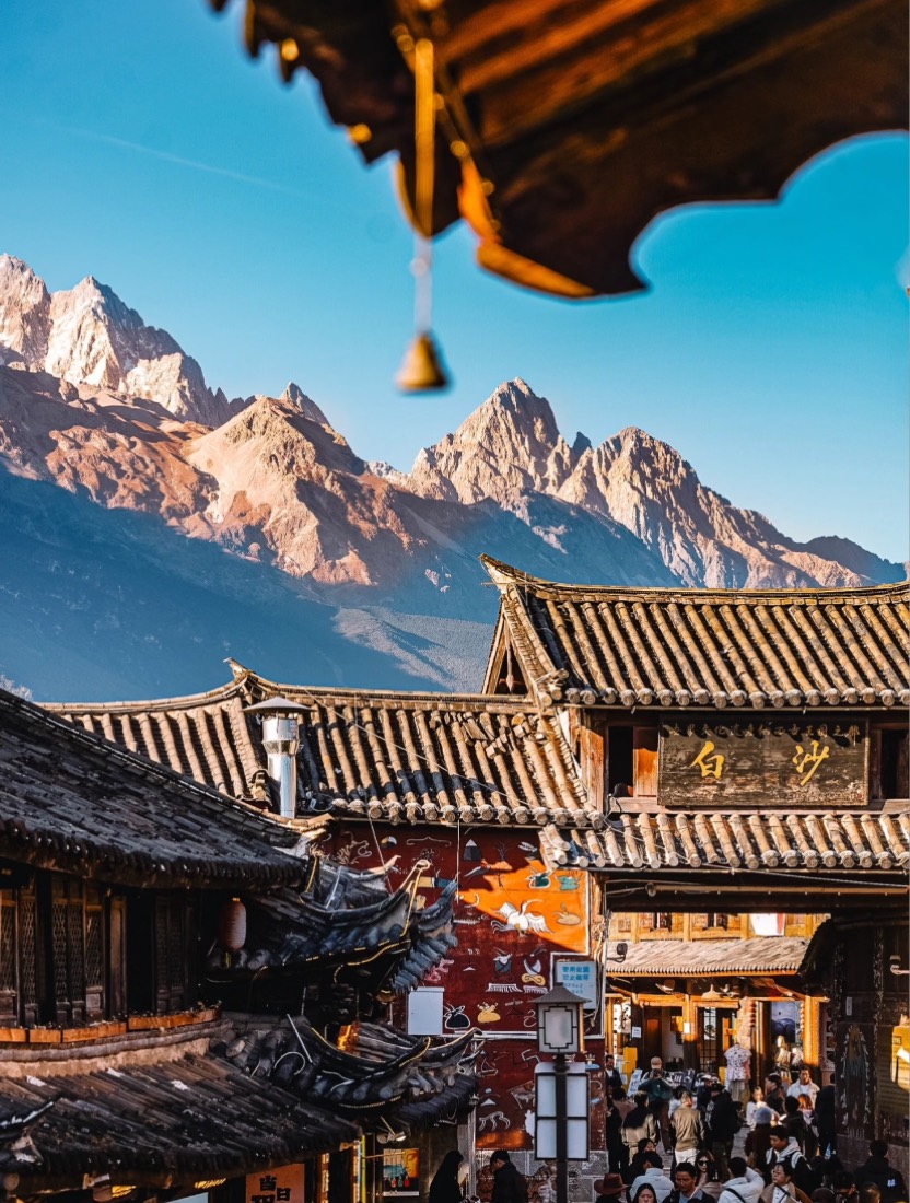 Lijiang old town rooftops beneath the snow-capped Jade Dragon mountain in Yunnan