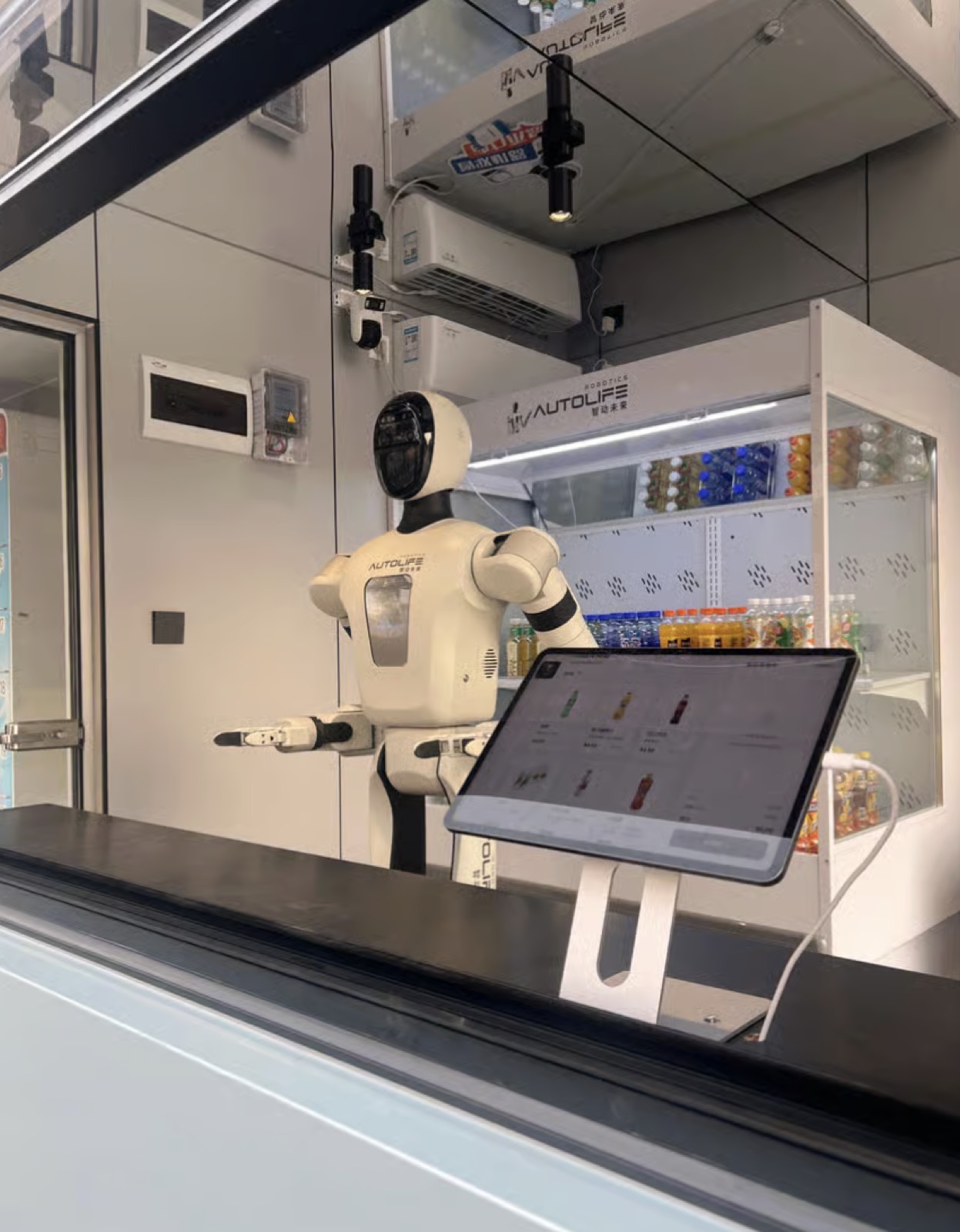 A cutting-edge service robot behind a counter with a touchscreen