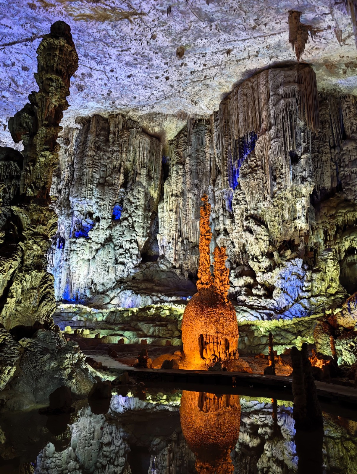 Illuminated stalactites and stalagmites inside an underground cavern in Guizhou