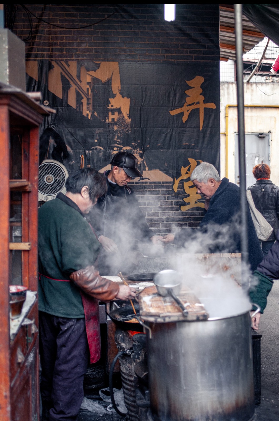 Steam rising from a Shanghai lane food stall