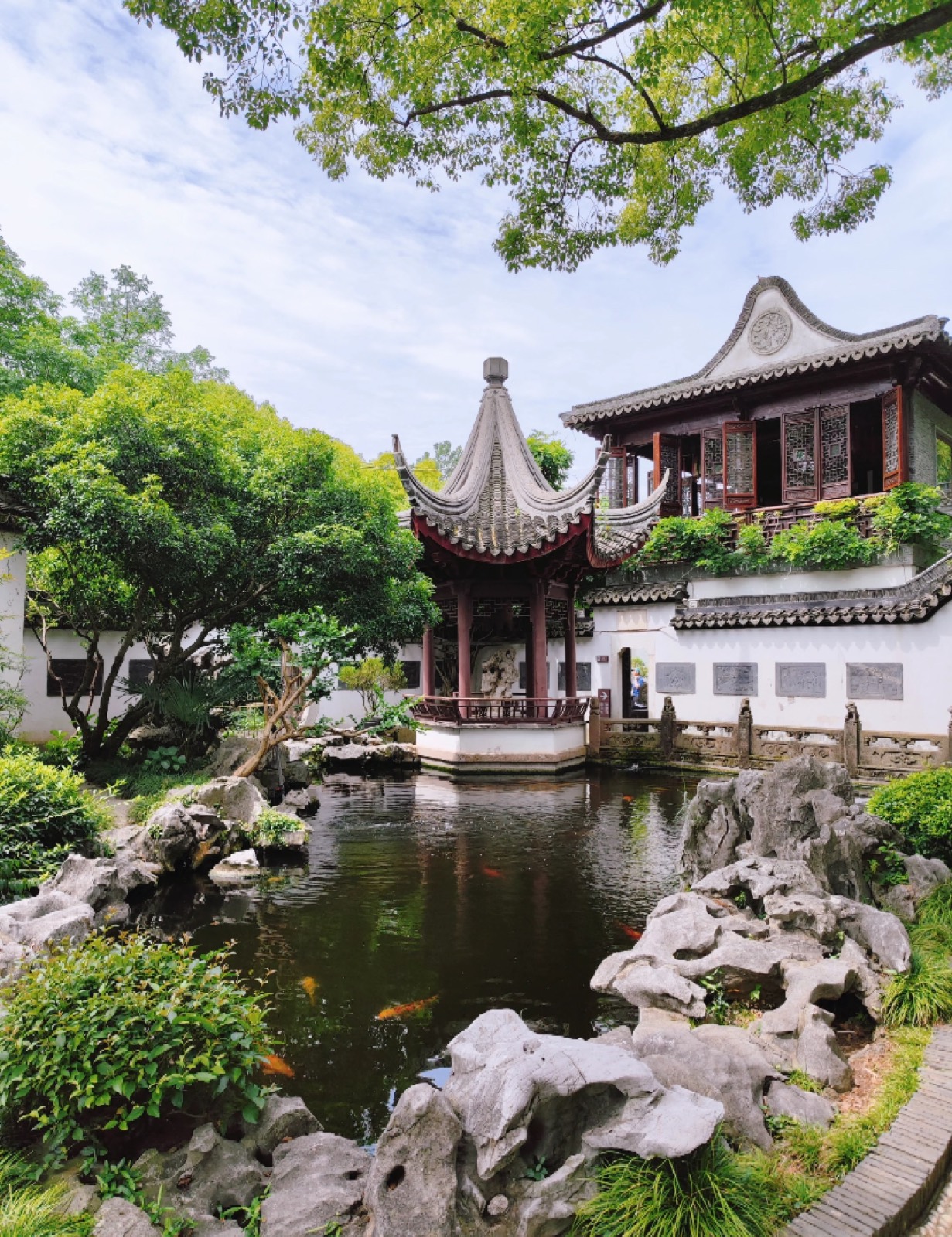 A classical pavilion over a koi pond at He Xin Yuan garden in Zhujiajiao
