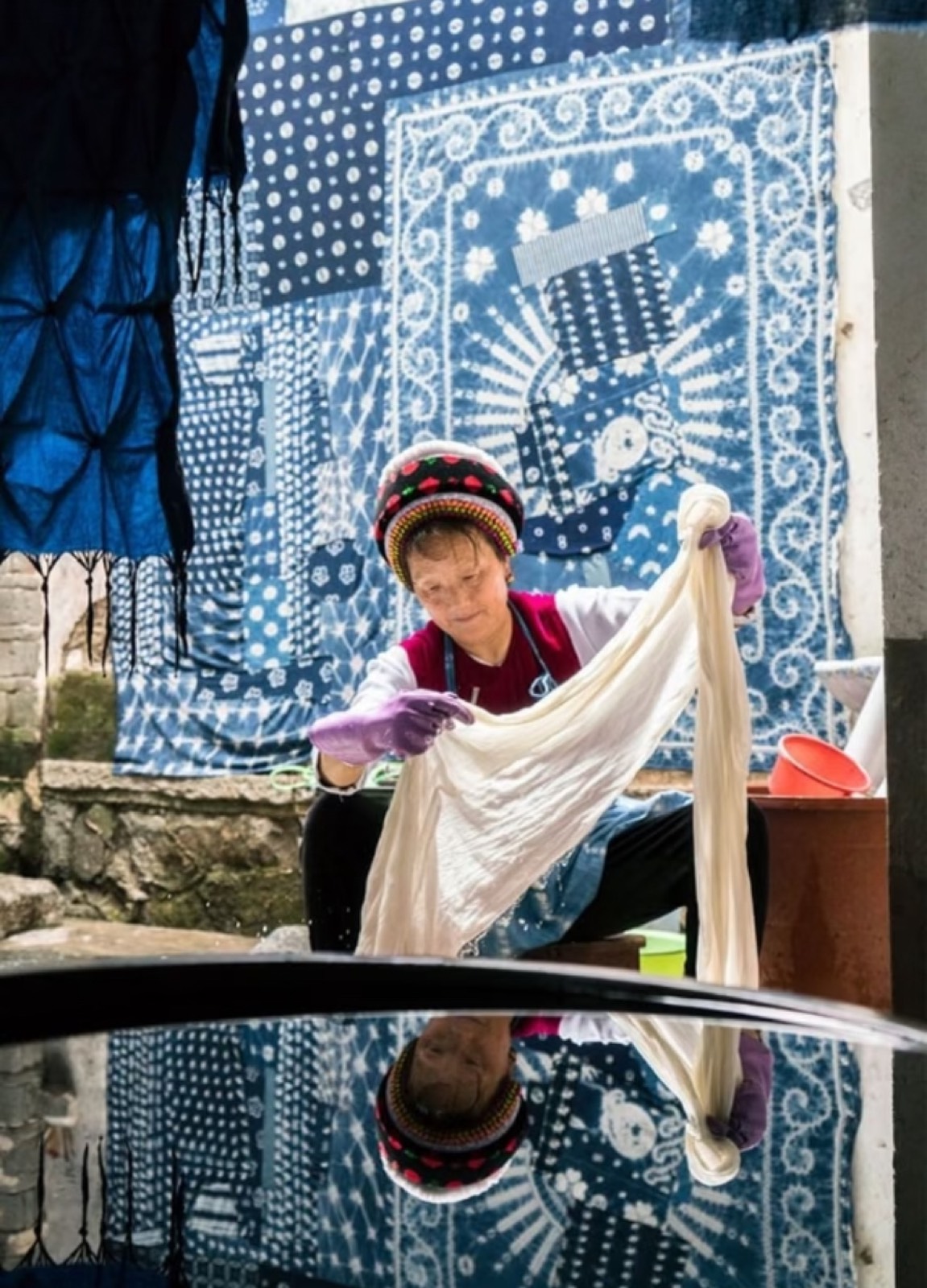 A Bai artisan working indigo tie-dye cloth in Yunnan