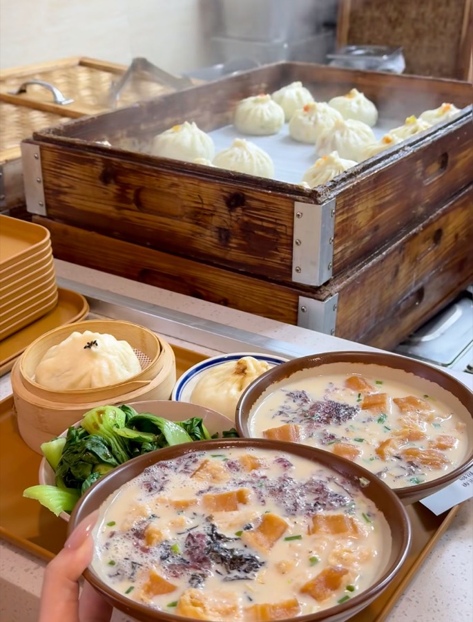 Bowls of soup dumplings and congee at a Chinese eatery