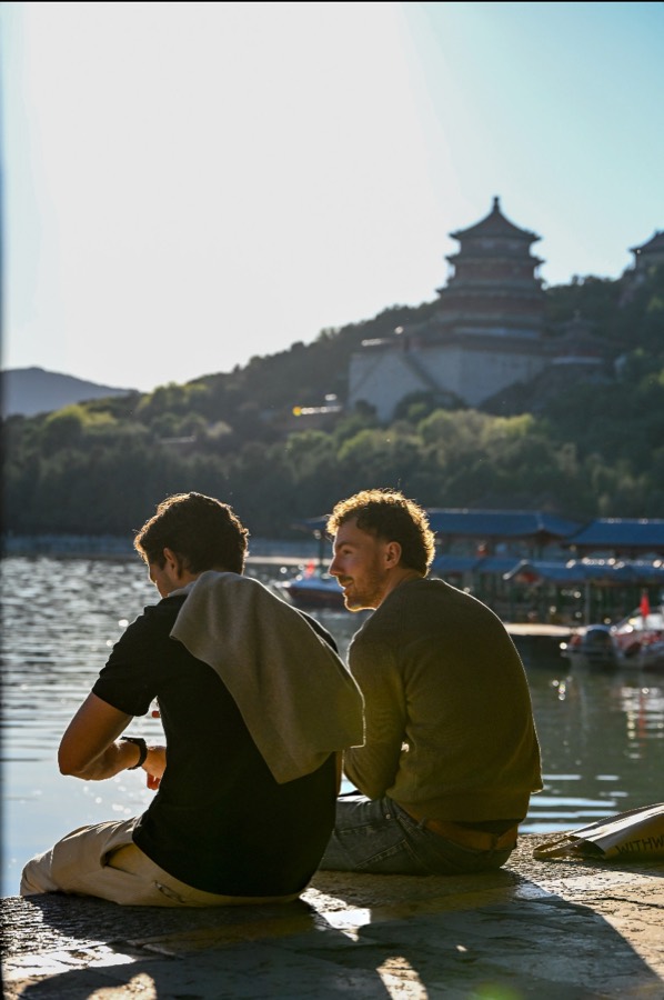 Travelers relaxing by a lake at the Summer Palace, Beijing