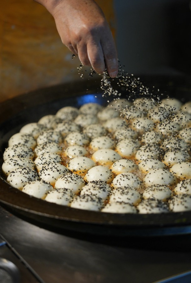 Freshly made pan-fried buns sprinkled with sesame
